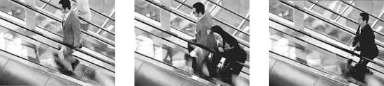 two briefcase carrying, business-suited adversaries in a knock down drag out fight on the escalator to nowhere.