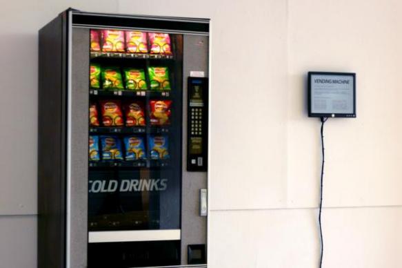 Ellie Harrison. Vending Machine. An installation for which an old vending machine is reprogrammed to release snacks only when news relating to the recession makes the headlines on the BBC News RSS feed.