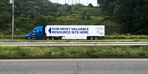 Truck with sign saying 'our most precious asset is here'