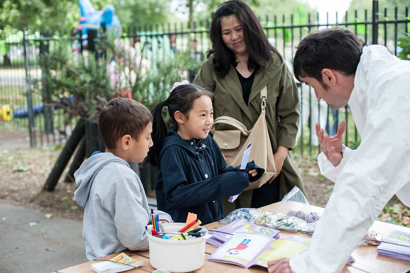 Image of a family playing Planet Cashless 2029 at the Furtherfield Future Fair on 10th August 2019, image credit: Julia Szalewicz
