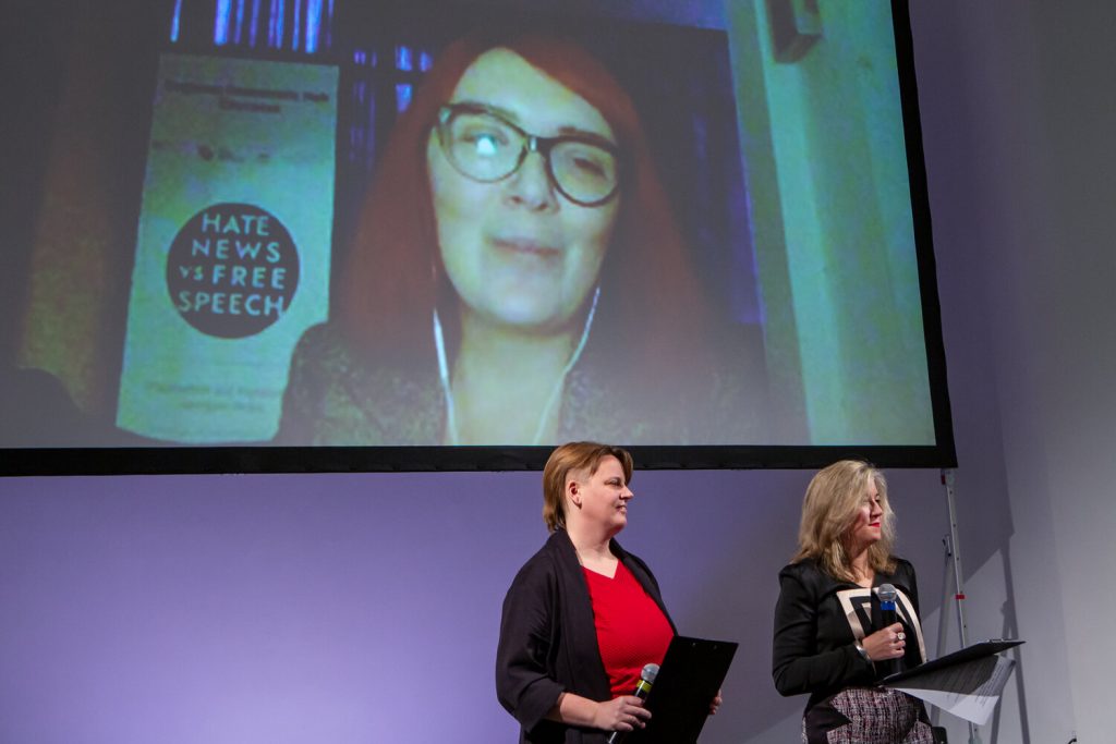 Maya Talakhadze, co-founder of the Regional Democratic Hub – Caucasus (screen), Lieke Ploeger, community director of the Disruption Network Lab, and Tatiana Bazzichelli, founder and director of the Distruption Network Lab opening the 22nd conference “Hate News VS Free Speech”